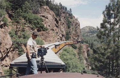 Rob Van Camp filming on top of a train at the Durango and Silverton Railway.